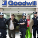 Goodwill executives are led from the company’s headquarters, where authorities reportedly found file cabinets filled with hundreds of Super Nintendo cartridges and needlepoint Christmas stockings.